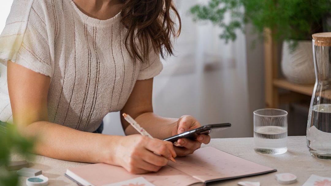 Photo by Svitlana a woman writing on a piece of paper