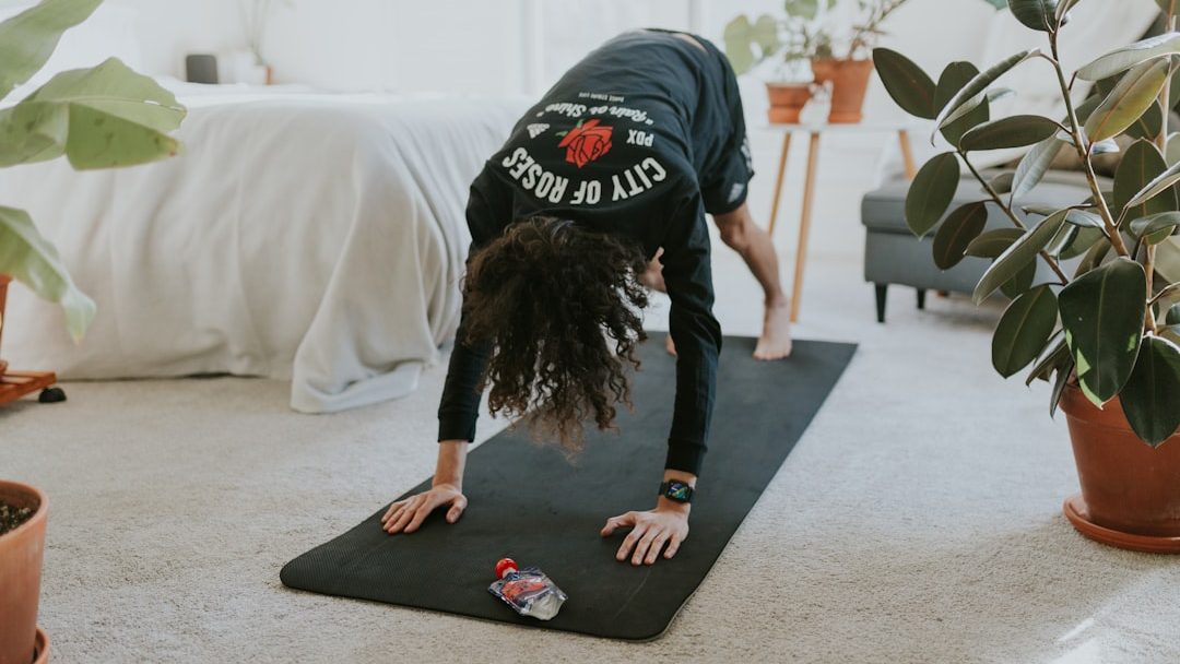 Photo by Cole Keister a woman is doing a yoga pose on a mat