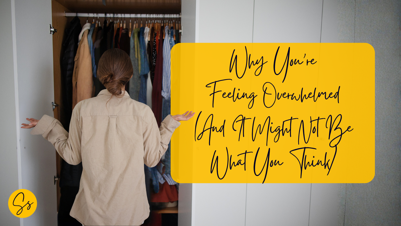 Person standing in front of a wardrobe full of clothes, illustrating decision fatigue, overwhelm and the impact of everyday friction on energy.